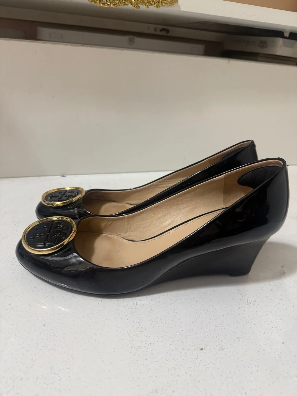 Tory Burch Black Patent Leather Wedges with Gold Logo Medallions
